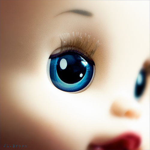 blue-eyed doll close-up photo of a doll with blue eyes