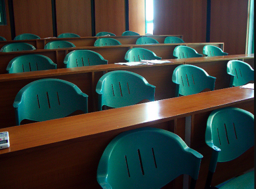 Classroom Chairs Tiered rows of green plastic chairs in a classroom