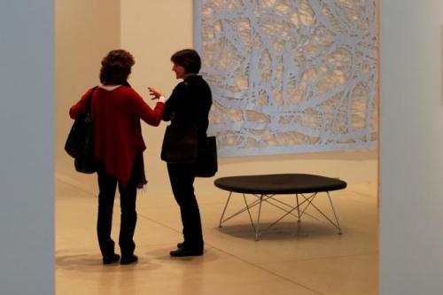 AGO Conversation Two woman conversing in an art gallery