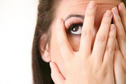 Woman covering face with hands in embarassment